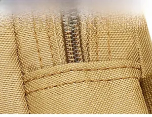 Close-up of double reinforced stitching on high-density khaki tactical shoulder bag fabric