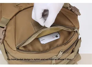 Front zipper pocket detail of khaki tactical backpack fitting a large smartphone