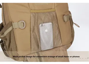 Close-up of tactical backpack mesh pocket with elastic cord holding a smartphone