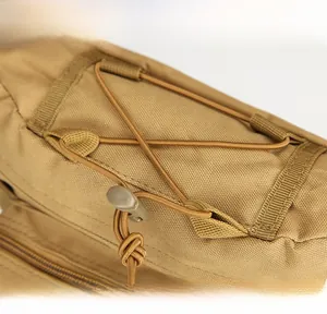 Detail view of the top bungee cord system on a durable khaki tactical waist bag