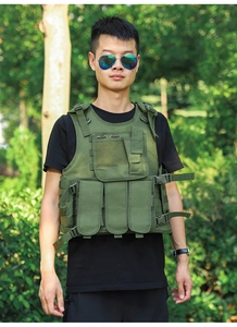 Detail of army green tactical vest showing MOLLE webbing and functional pouches