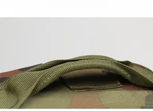 Reinforced webbing handle on camouflage tactical backpack with heavy-duty stitching detail