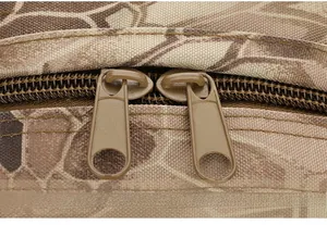 Detail of durable two-way matte khaki zippers on tactical camouflage hiking backpack