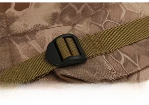 Detail of adjustable tactical shoulder strap buckle on camouflage hiking backpack