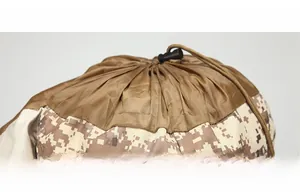 Detail view of adjustable brown drawstring and black plastic toggle on digital camo tactical bag