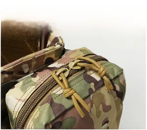 Close-up of durable tactical vest zipper system with paracord pullers in multicam pattern