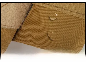 Detailed macro shot of tan tactical vest showing waterproof fabric with water droplets