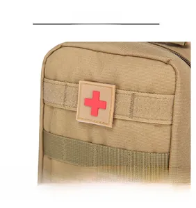 Detail of the sand tactical first aid kit showing MOLLE webbing and red cross velcro patch