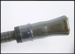 Macro view of the dark green TPU water bag mouthpiece with black corrugated hose detail