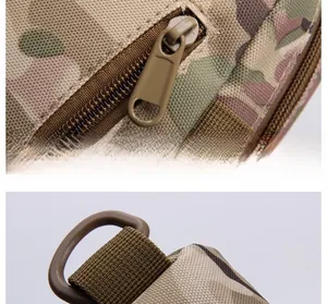 Detail of durable camo tactical bag showing metal zipper with large ring and plastic D-buckle