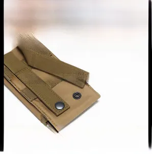Tactical accessory pouch showing MOLLE system webbing and metal snaps on khaki nylon