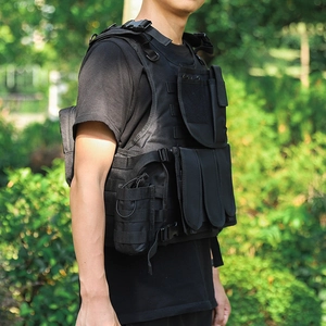 Detail view of black tactical vest with MOLLE system and multiple functional pockets