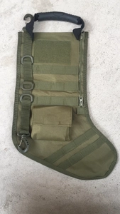 Army green tactical Christmas stocking detail with MOLLE system and rubber handle