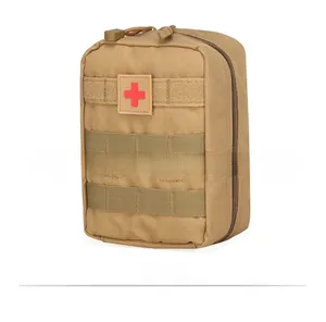 Macro side view of khaki tactical first aid pouch with MOLLE webbing and red cross