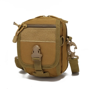 Detailed macro view of the tactical coyote brown MOLLE accessory pouch with velcro panel