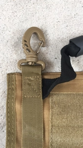 Detail of tan tactical bag featuring durable swivel hook and heavy-duty nylon webbing
