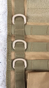 Detail of Molle tactical bag featuring durable nylon straps and D-rings for gear attachment