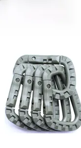 Detail of four army green tactical D-ring carabiners for outdoor gear and backpacks