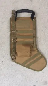 Detailed view of khaki tactical Christmas stocking with MOLLE webbing and side zipper