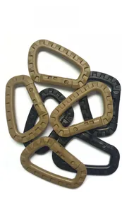 Close-up of black and tan tactical carabiners showing non-slip ribs and locking gear