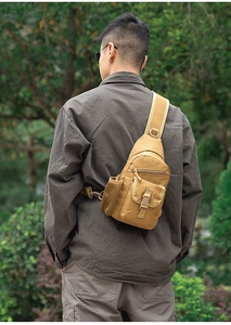 Detail view of khaki tactical chest bag showing durable nylon material and side mesh pocket