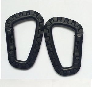 Close-up of dual black tactical D-ring carabiners with non-slip texture and spring gate
