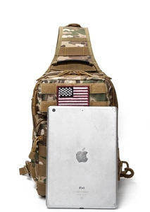 Tactical camo chest bag with MOLLE webbing and flag patch shown next to an iPad for size