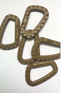Close-up of five coyote brown tactical D-ring carabiners made of durable plastic