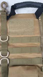 Close-up of tactical bag featuring MOLLE system, rubber handle, and D-ring in khaki nylon
