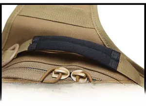 Close-up of khaki nylon tactical bag featuring a black cotton handle and dual paracord zippers