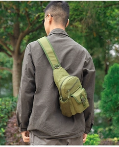 Close-up of military green tactical chest bag with heavy-duty buckles and mesh side pocket