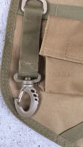 Macro detail of coyote brown tactical bag with swivel snap hook and nylon webbing strap