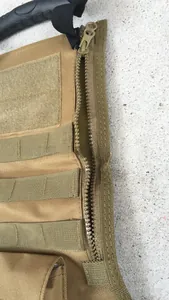 Close-up of tactical nylon bag with MOLLE webbing and reinforced rubber handle