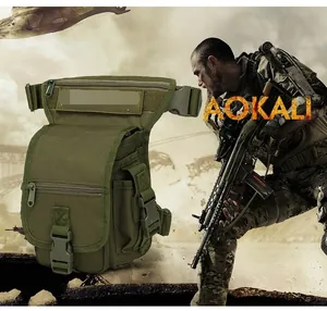 Close-up of military green tactical leg bag with multi-pocket design and MOLLE system