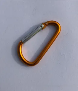 Detail shot of an orange D-shaped aluminum carabiner with a silver spring gate