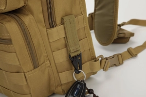 Detail of high-density nylon fabric and MOLLE webbing on a tactical coyote brown bag