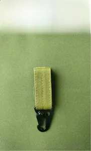 Macro shot of durable tactical MOLLE nylon webbing with a matte black metal carabiner hook