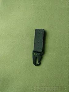 Tactical black nylon webbing hook with metal HK clip on green canvas background
