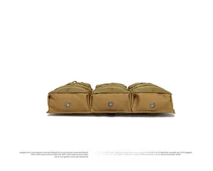 Detail view of tactical mag pouch bottom with three metal drainage eyelets and tan nylon fabric