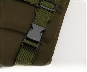 Detail of high-strength tactical buckle and durable nylon strap on green outdoor backpack