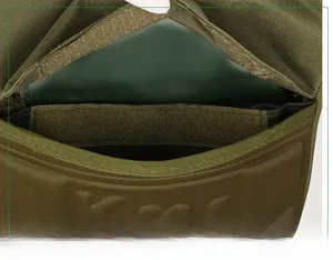 Detail of military green tactical backpack showing secure Velcro closure and durable nylon