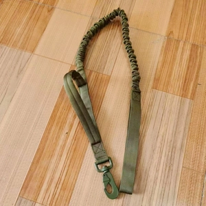 Detail view of military green tactical bungee sling with heavy duty metal carabiner clip