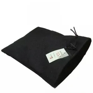 Detailed close-up of a black drawstring velvet pouch with a white certificate tag attached