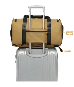 Detail of khaki tactical travel bag showing the zipper pocket and luggage handle sleeve