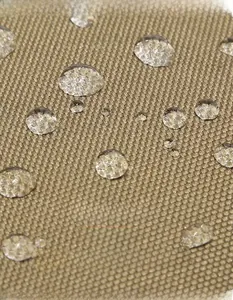 Macro shot of khaki waterproof fabric showing water droplets on the tactical backpack surface