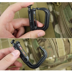 Close-up of black tactical D-ring carabiner showing manual locking mechanism on MOLLE webbing