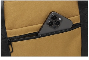 Close-up of tactical bag zipper pocket showing fabric texture and phone storage space