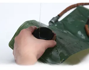 Detail showing water being poured into a 3L TPU hydration bladder with screw cap