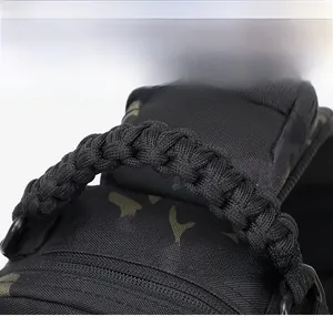 Close-up of durable paracord woven handle on waterproof camouflage tactical chest bag