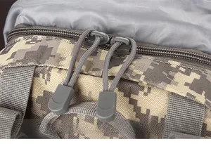 Detail of durable dual zippers and paracord pulls on digital desert camo tactical backpack